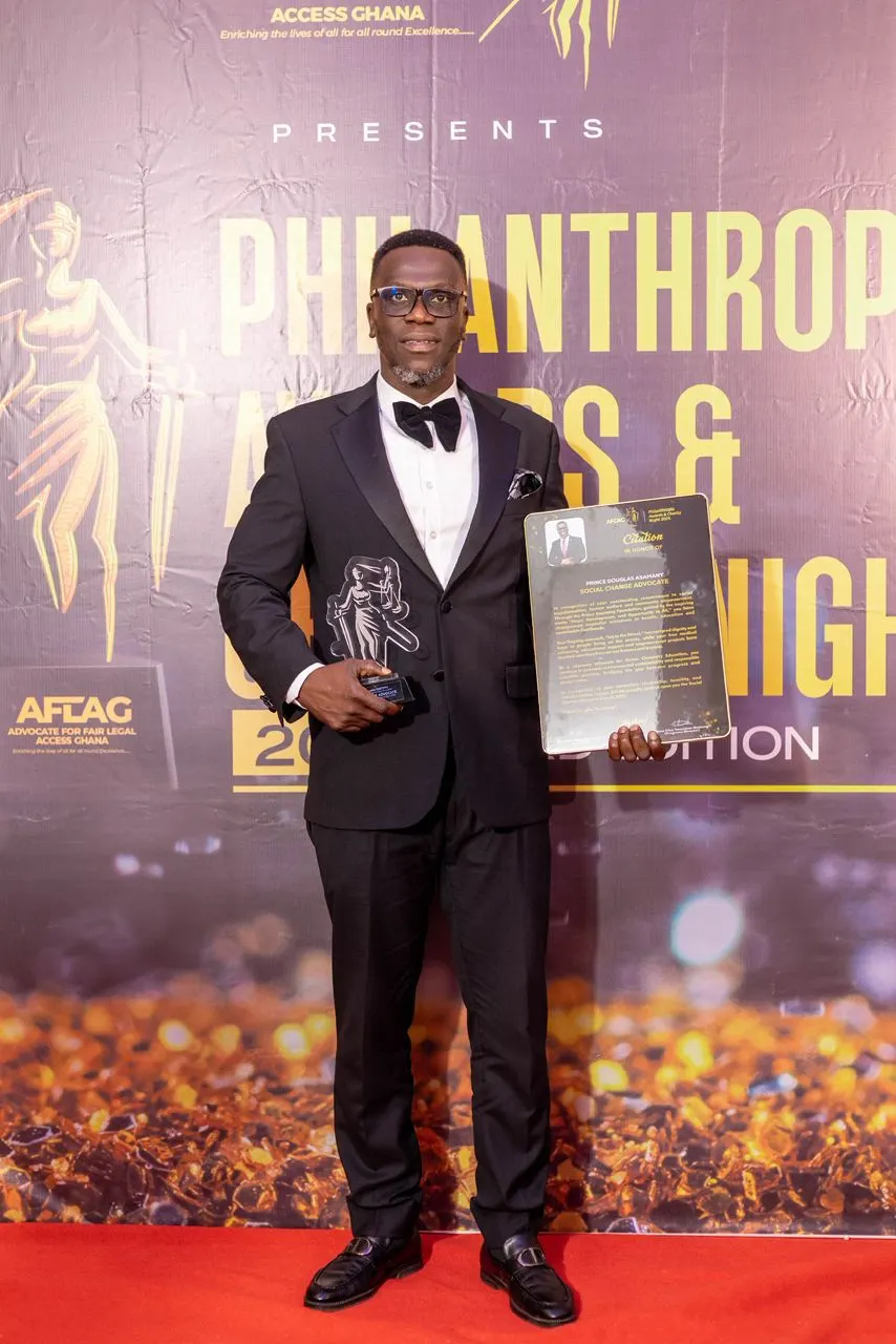Prince Douglas Asamany on the red carpet holding the 2025 Social Change Advocate Award trophy and citation