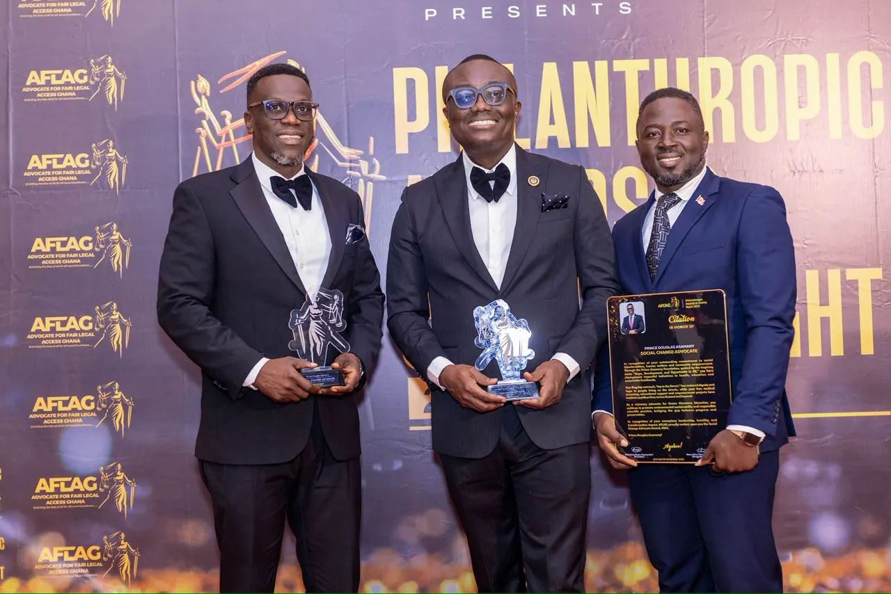 Prince Douglas Asamany with fellow honorees holding their trophies at the Philanthropic Awards & Charity Night
