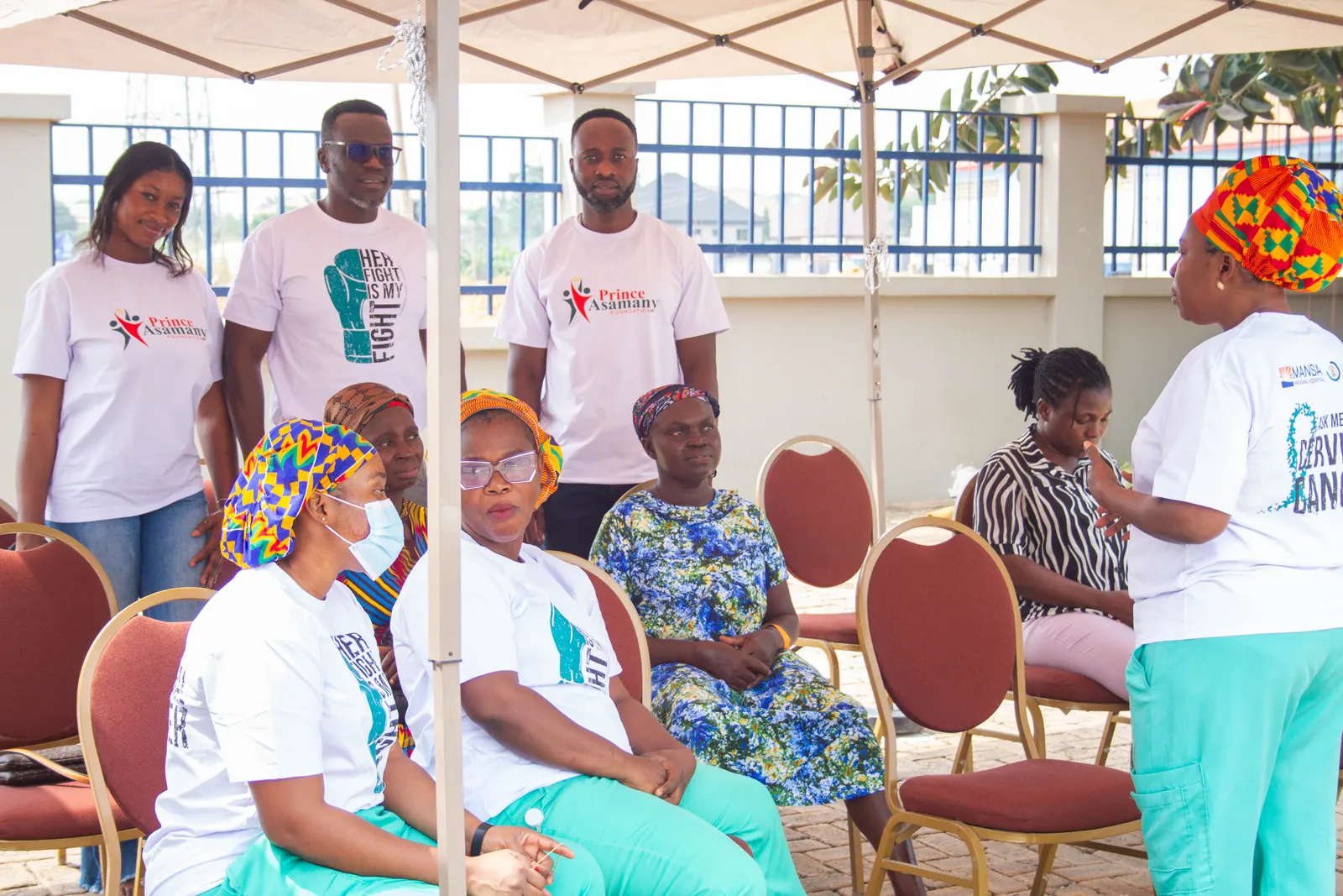 Foundation team and health workers posing with a banner at a free cervical cancer screening event