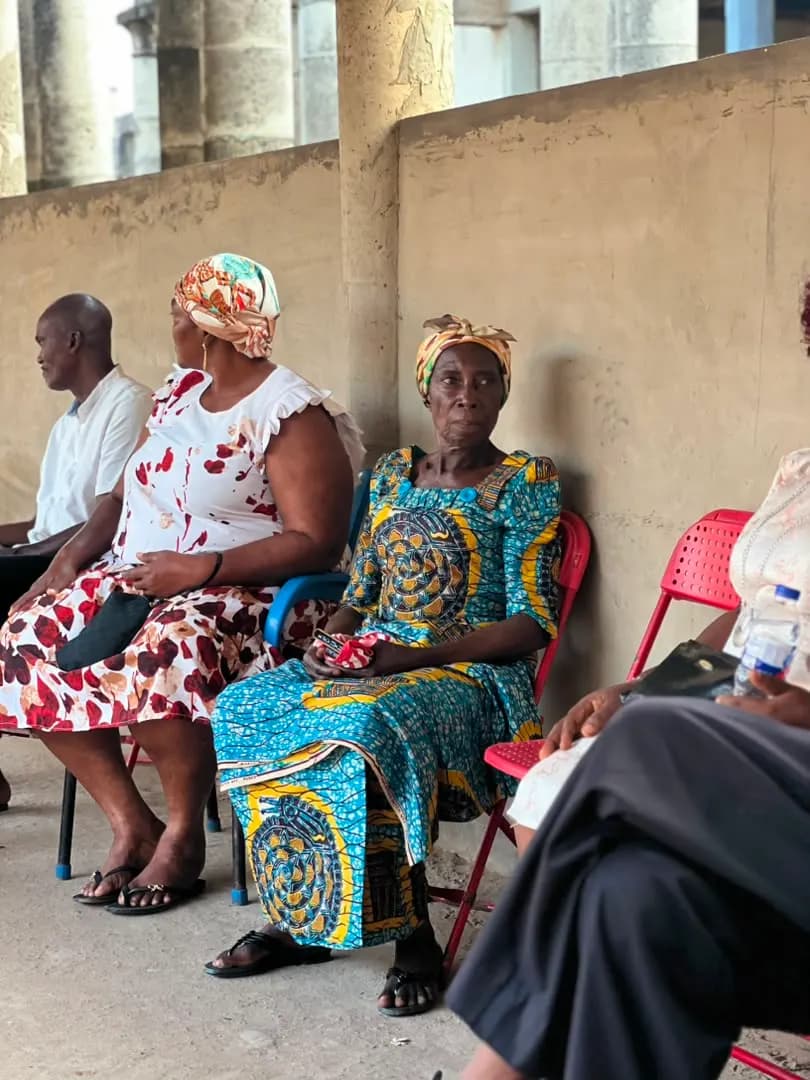 Farmers and residents gather under a covered structure during the engagement